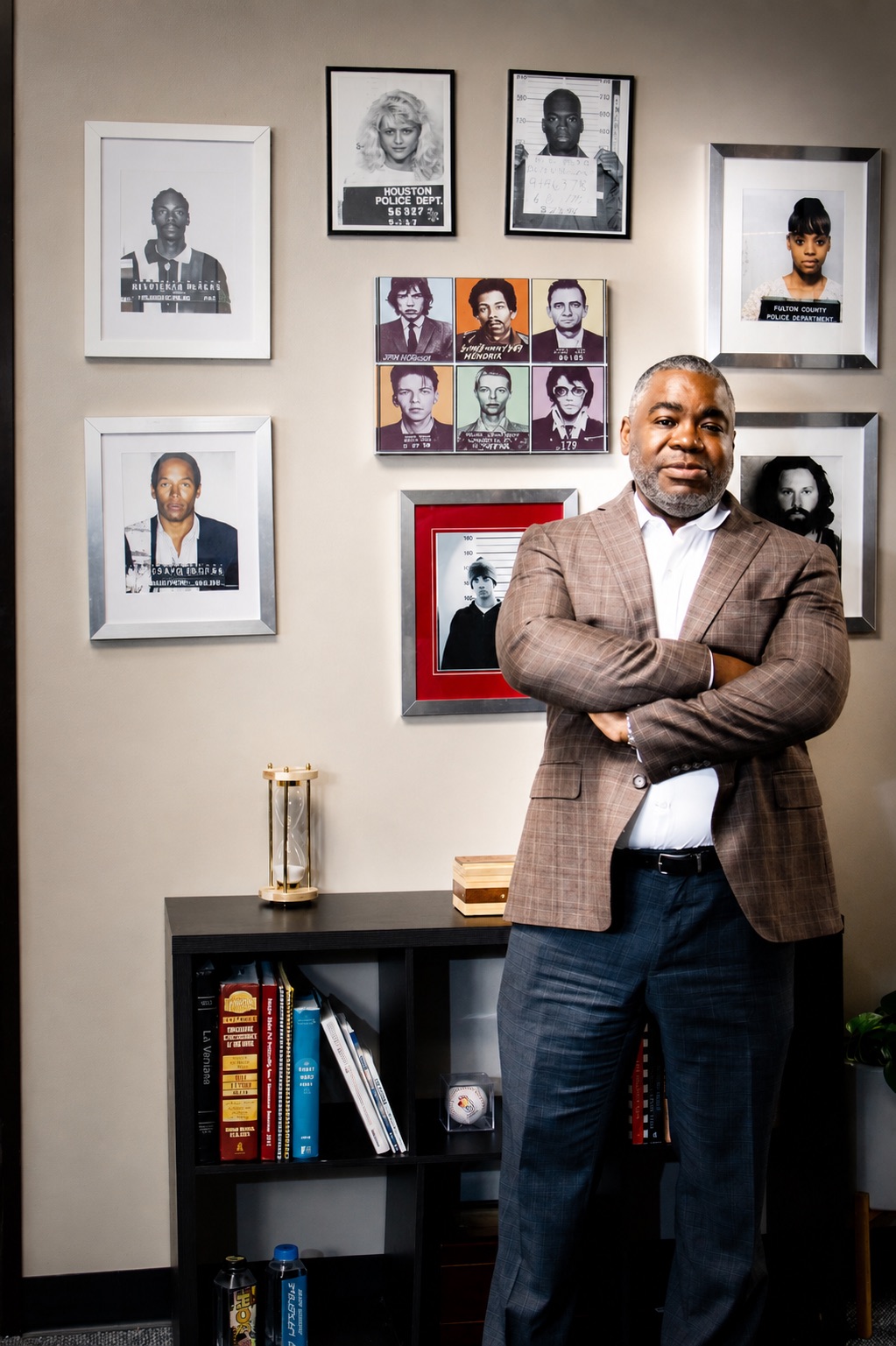 T. Christopher Lewis standing with arms crossed in his Dallas office