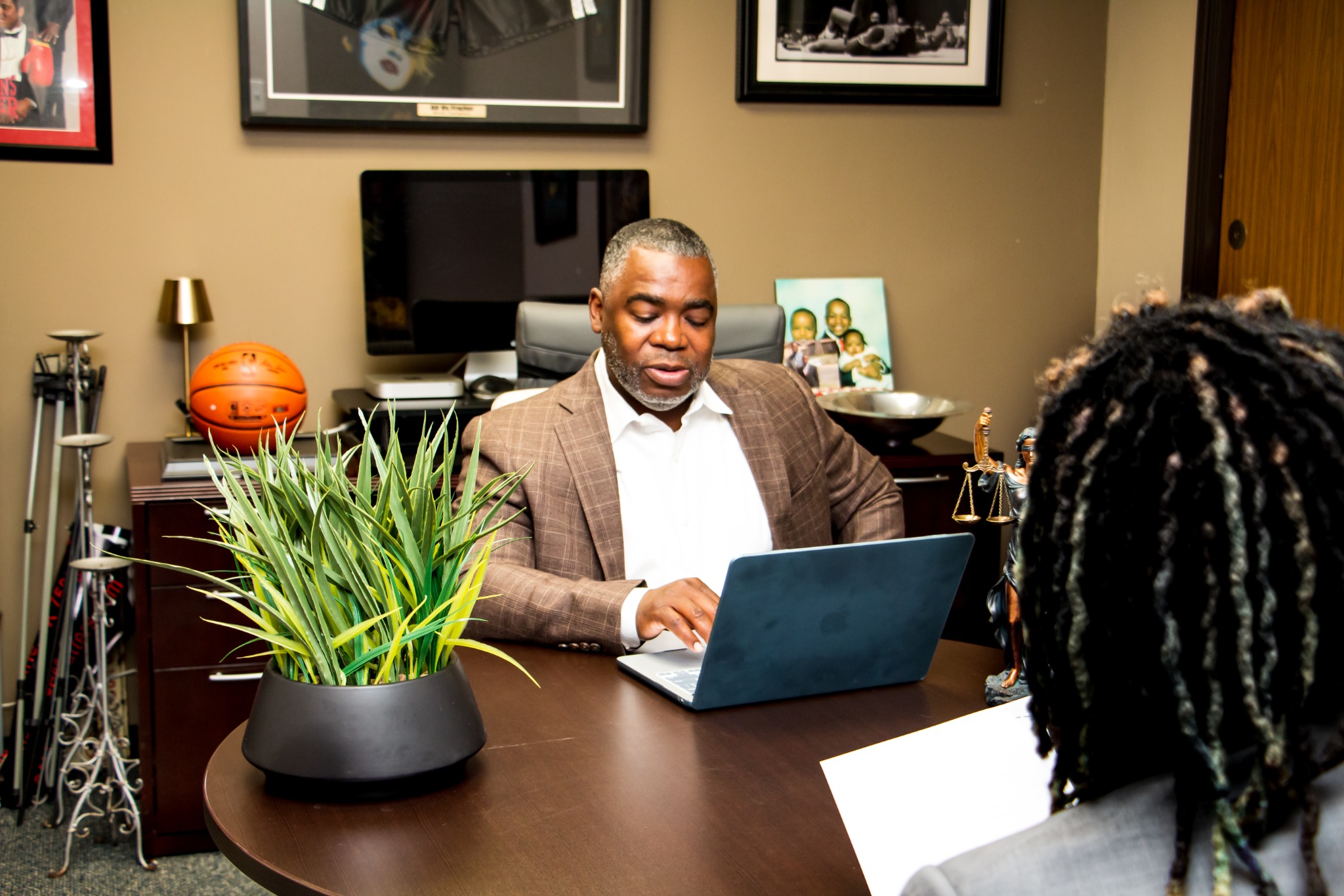 T. Christopher Lewis meeting with a client across the desk in his Dallas office