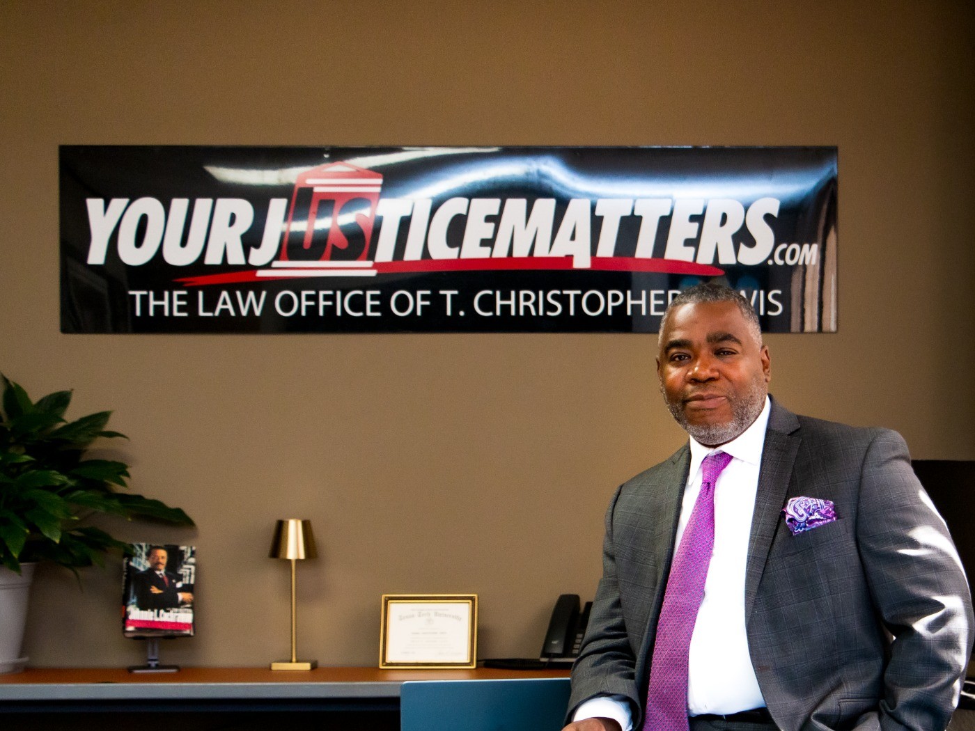 T. Christopher Lewis reviewing a case file at his desk